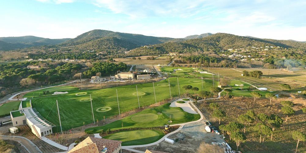 Greenwich Aerial view of a synthetic grass golf course surrounded by hills