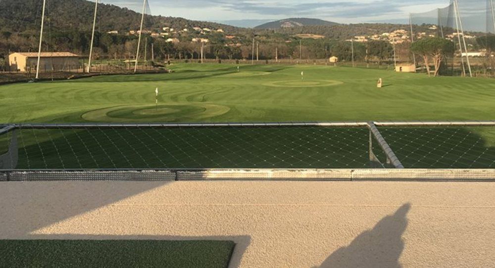 Greenwich Synthetic turf beside natural grass golf course